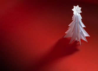 Wall Mural - Christmas trees made of paper on red background. Christmas card