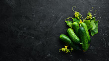 Fresh Cucumbers With Green Leaves On A Black Background. Top View. Free Space For Your Text.