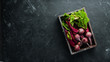 Fresh beetroot with leaves on a black stone background. Healthy food. Top view. Free space for your text.