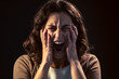 © nenetus - A young woman close-up screaming on black background. Mental illness concept.