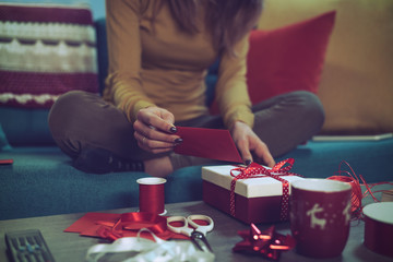 Woman preparing Christmas gifts at home