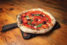 Freshly Baked Pizza On A Wooden Table