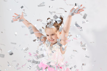 Party, holidays, birthday, new year and celebration concept - Cute child throwing confetti.