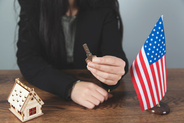 Wall Mural - woman hand with house model and key