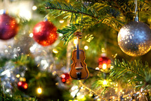Violin In Christmas Tree Decoration With Red And Silver Baubles