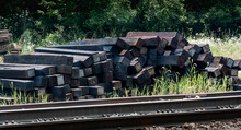 Railroad Ties Stacked Next To Tracks