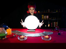 Asian Fortune Teller Gypsy Style Female Forecast Future Life And Love Destiny With Tarot Cards And Crystal Light Ball Gazing By Magic Mystery Power On Luxury Red Tablecloth In Dark Witch Scene