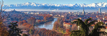 Aerial Panoramic Winter View On Turin City Center With Mole Antonelliana, Modern Skyscrapers And Other Buildings, Clear Blue Sky Morning With Alps Full Of Snow On Background