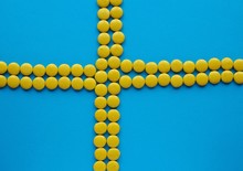 The Swedish Flag Made Of Yellow Candy On Blue Solid Background