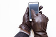 © Fox - Leather gloves touch and smartphone. White background, isolated