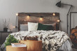 Christmas bedroom decor with lights, wood, spruce and cones