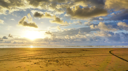 Stunning and beautiful sunset time over the Pacific Ocean. Massive beach and colourful sky background photo.