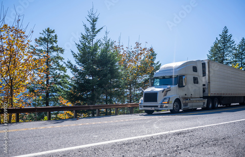 Big Rig Semi Truck Transporting Cargo In Refrigerated Semi Trailer Going Downhill On The Road With Autumn Trees In Columbia Gorge Area Stock Photo Adobe Stock