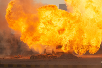 Wall Mural - Military strike or bomb in war on a car causes fire ball and explosion in the town in chaos. Military war concept. Strength, power, force, fire, explosion.