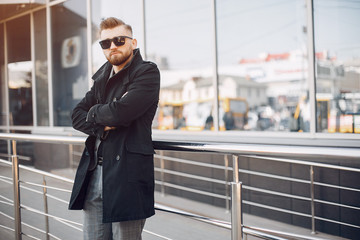 Man in a stylish suit. Businessman in a summer city