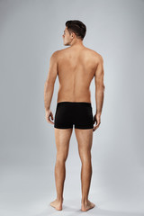 Sticker - Handsome man in black underwear on light grey background, back view