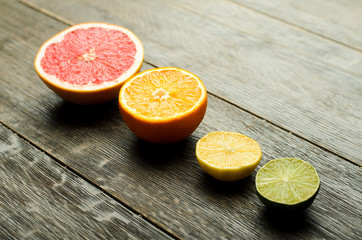 Row of colorful citrus slices on a wooden background