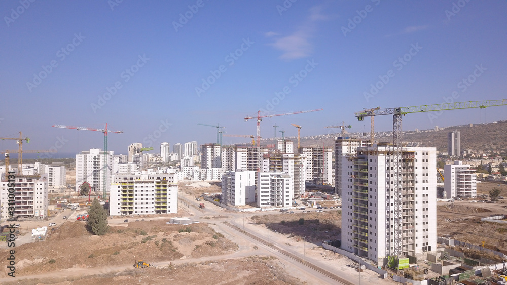 Residential construction site. Tower cranes build large residential ...