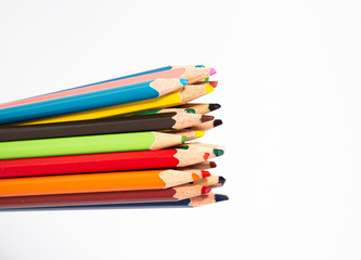 Assortment of coloured pencils on white background