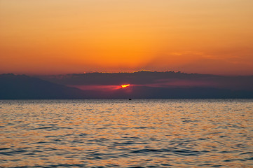 Dramatic sunset over sea and mountain. Photographed in Pirgos Sani on Halkidiki Greece.