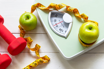 diet and healthy life loss weight concept. green apple and weight scale measure tap with fresh veget