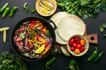 Grilled skirt steak and stir fried vegetables fajitas, top down view