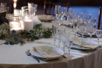 Wall Mural - Glass vases with burning candles stand on the festive table on the wedding day. Table set