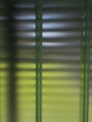 Poster - Rippled glass blocks of backlit semitransparent wall or window. Close-up of modern architecture or interior design. Crystal mosaic material pattern. Technology background in green and blue colors.