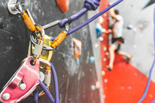 Close-up Detail Of Rock Climber Wearing Safety Harness And Climbing Equipment Outdoor. Climbing Carabiner Insurance.