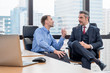 © Sathaporn - Young Caucasian worker sitting and discussion or explain about work with Caucasian boss or CEO. in meeting room in workplace
