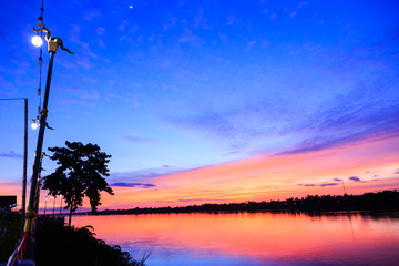 Wall Mural - Fantasy twilight dawn background, Gold sunlight on blue sky and moving soft purple clouds above before sunset-Mae khong river, Thailand