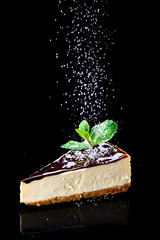 Wall Mural - cheesecake with chocolate and mint on a dark background