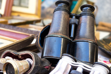 old binoculars exposed on the counter of an antique market