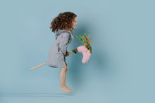 The Curly Girl Plays With Stick Horse.