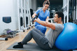 © Peakstock - kinesiologist helps a mixed race man doing exercises to strengthen his back muscles. treatment of back pain using kinesitherapy.