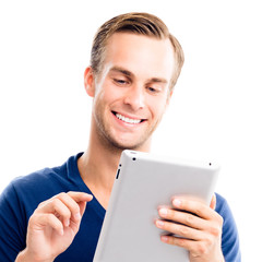 Wall Mural - Portrait of happy smiling handsome man in blue smart casual clothing, using no-name tablet pc, isolated against white background