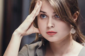 face of a tired woman after work, propping her head on her hand, concept price of success, business difficulties, modern lady's lifestyle