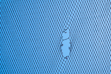torn fishing net and blue sky