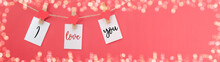 Happy Valentine's Day Background Banner Panorama Long - White Notes Of Paper Hang On Wooden Clothes Pegs With Hearts On A String Isolated On Living Coral Texture Frame Bokeh, With Space For Text