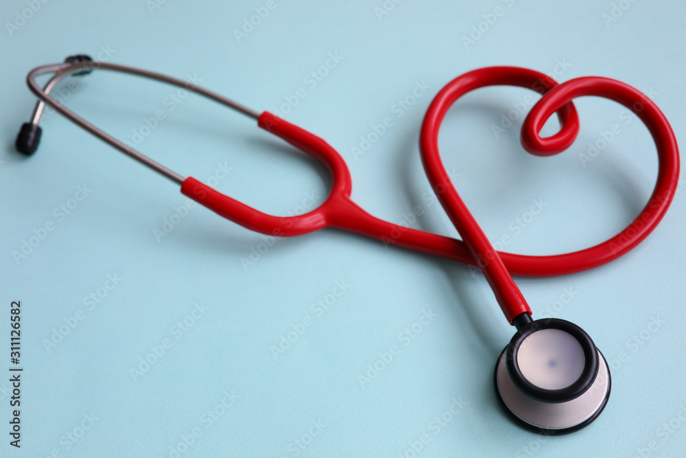 Red stethoscope with heart on blue modern background