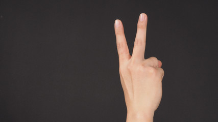 Wall Mural - Peace sign.It is hand gesturing two finger on white background