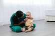 © Rakchanok - Asian pediatrician doctor woman green uniform hold stethoscope annual check up toddler boy by monitoring heart pulse rate , nurse play with preschool boy during examination, child health care concept