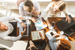 © xartproduction - A team of young businessmen working and communicating together in an office. Corporate businessteam and manager in a meeting.