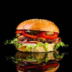 Canvas Print - fast food juicy burger on a black background