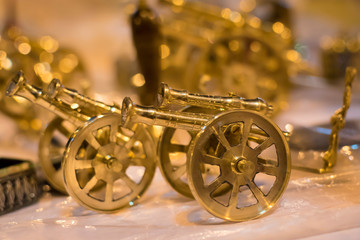 Beautiful handmade toy cannon displayed in a shop for sale in blurred background. Indian handicraft.