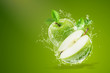 Water splashing on Fresh green apple on Green background