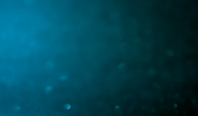 Wall Mural - blue abstract glitter bokeh on black background
