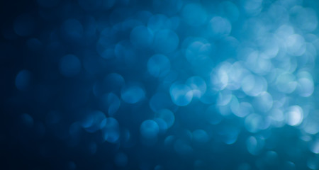 Wall Mural - blue abstract glitter bokeh on black background