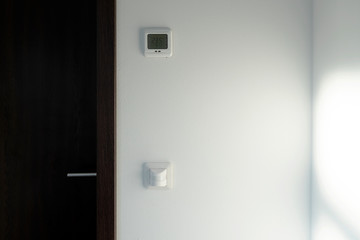 Smart home system. The room has a motion sensor to turn on the light. There is a climate control of the temperature.