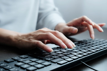 2 hands of Asian woman is press, typing on 2 language keyboard as Thai and English. Maybe preparation about information to report, chat to lover or shopping online by connect to internet at home, cafe